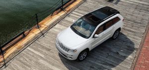 White Jeep Grand Cherokee from bird's eye-view parked on a dock.