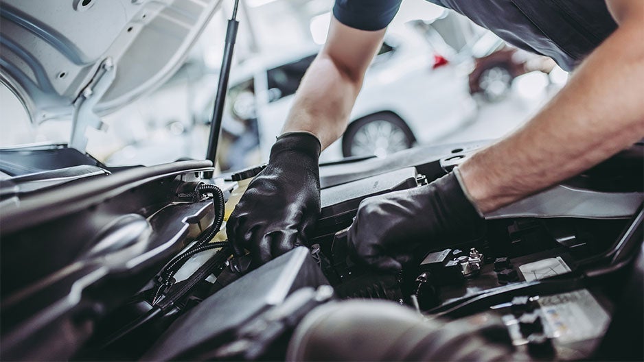 Automotive technician working on an engine